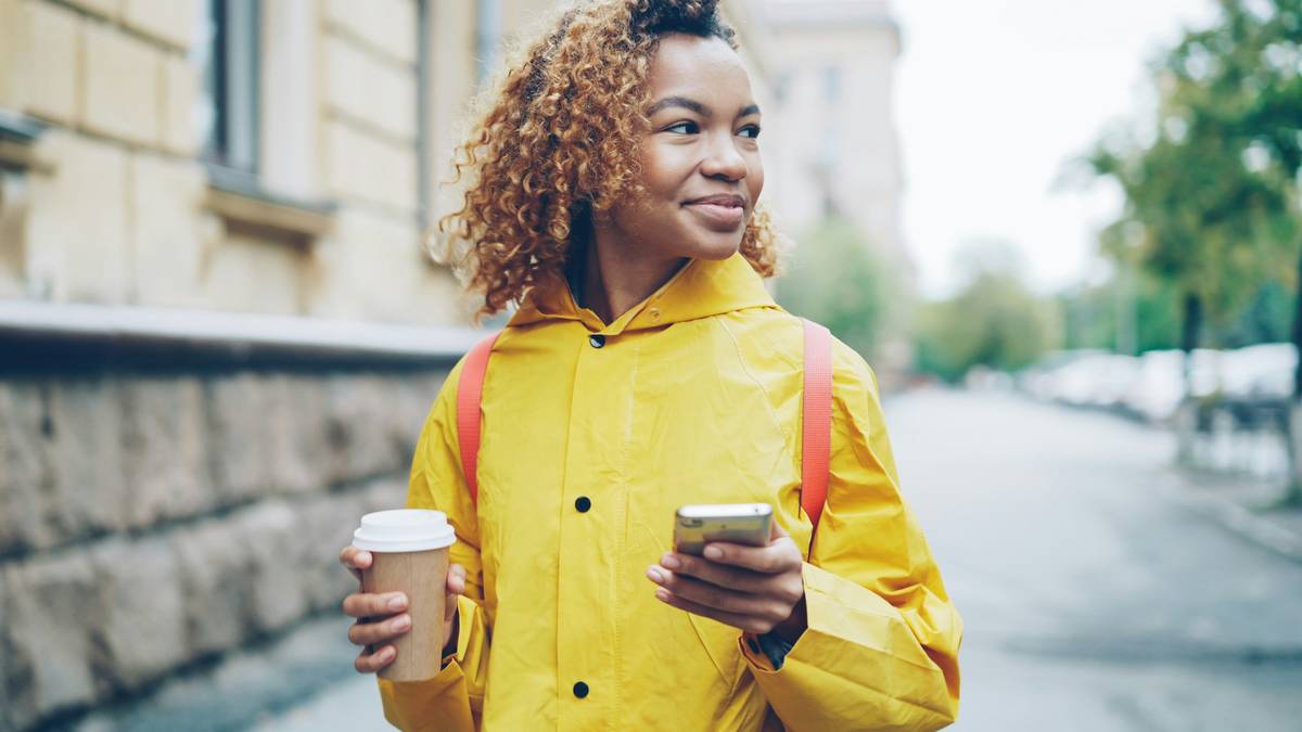 Traveler wearing Lightweight Rain Jackets in urban downpour