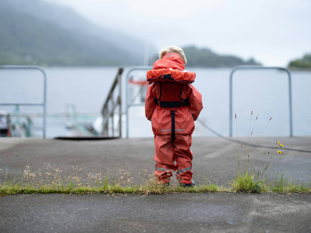 Hiker wearing Anti-Sweat Rain Jackets while trekking in light rain, showing breathable fabric in action