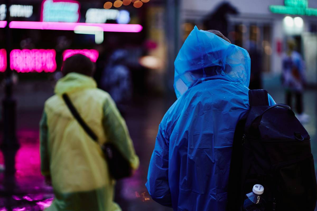 Traveler using downpour gear rain protection should you tested in heavy rain with waterproof backpack cover and rain jacket